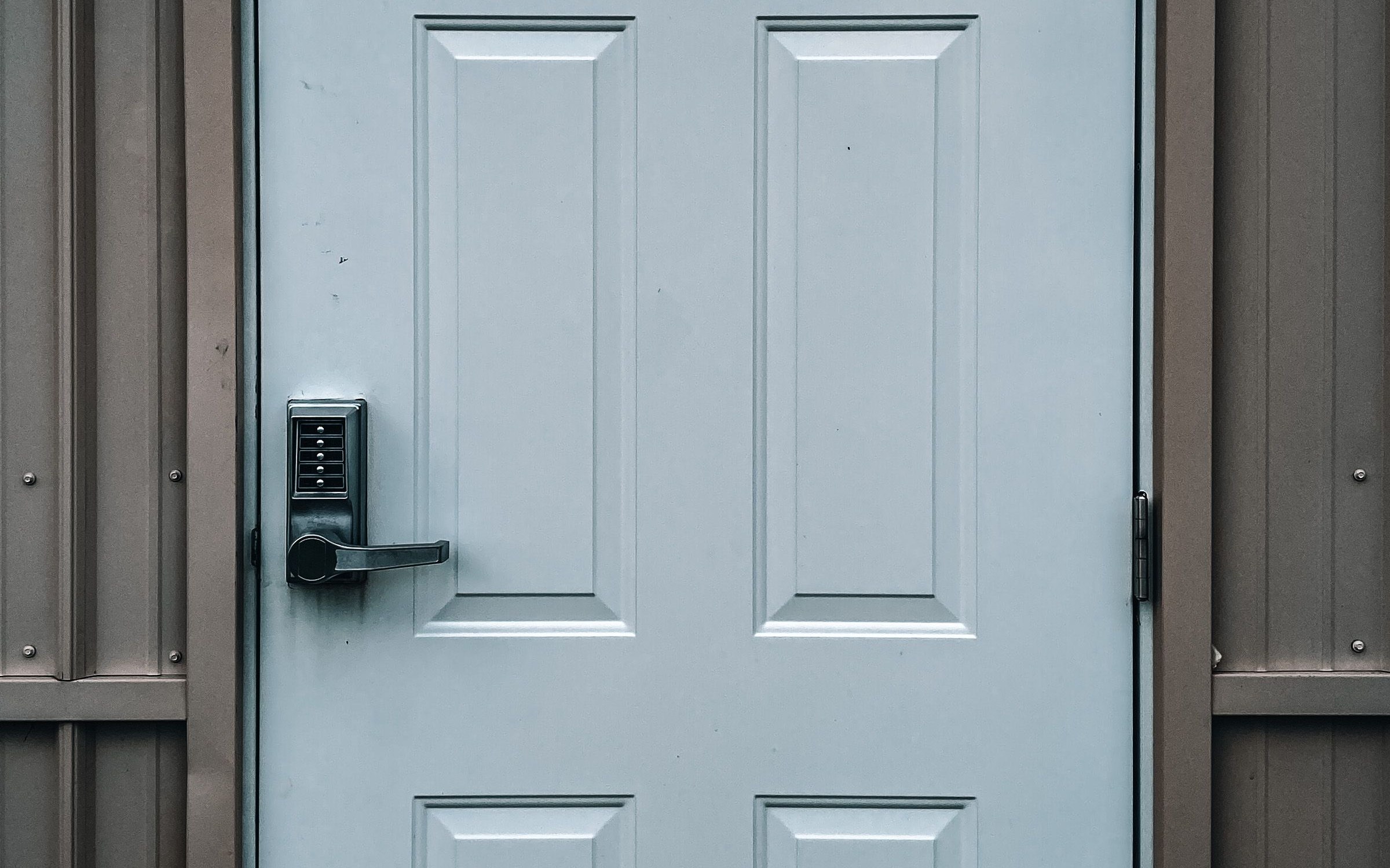 Keypad lock and lever on a white exterior door